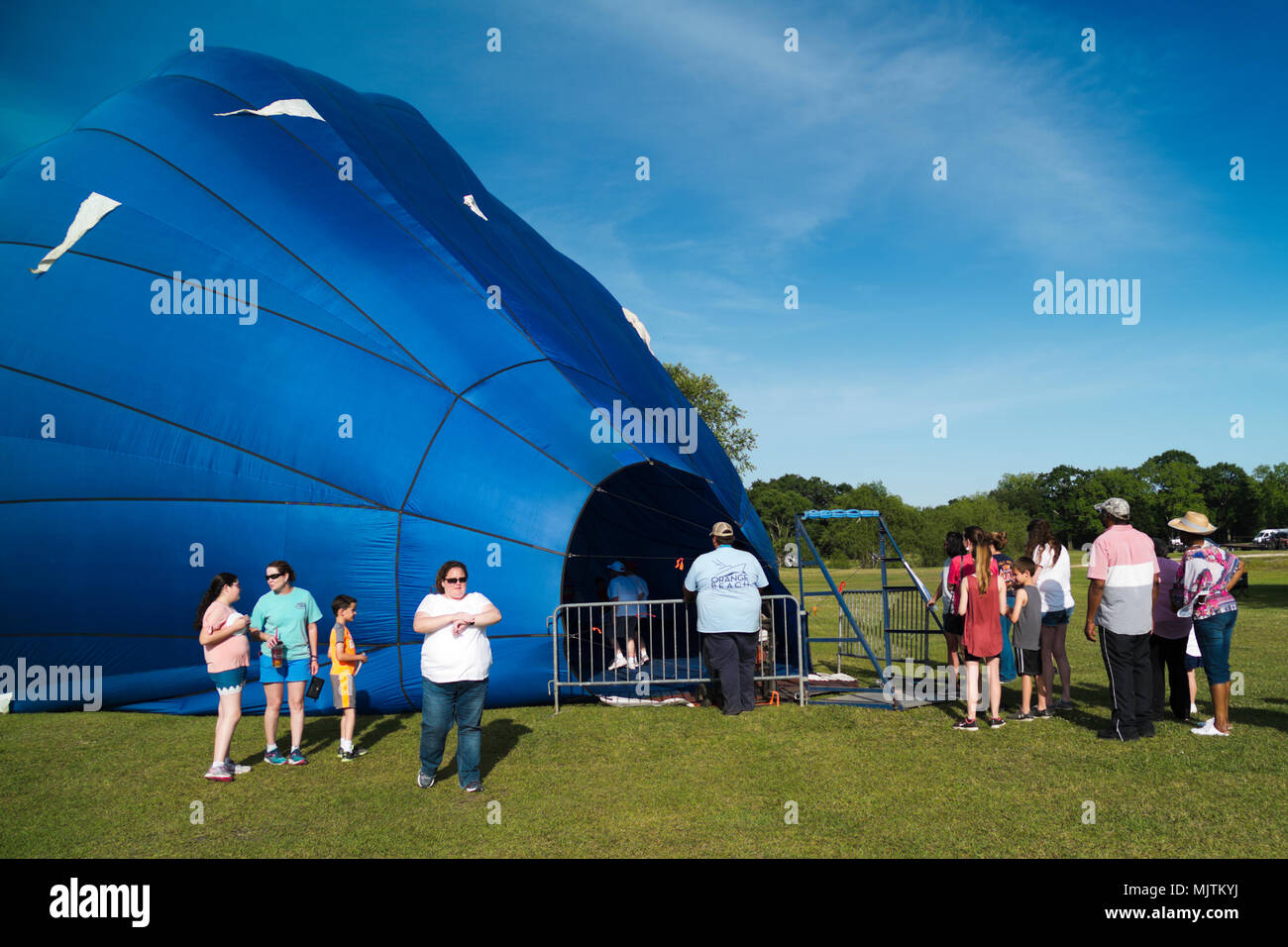 People Lined Up To Walk Inside A Partially Inflated Hot Air Balloon At People Lined Up To Walk Inside A Partially Inflated Hot Air Balloon At