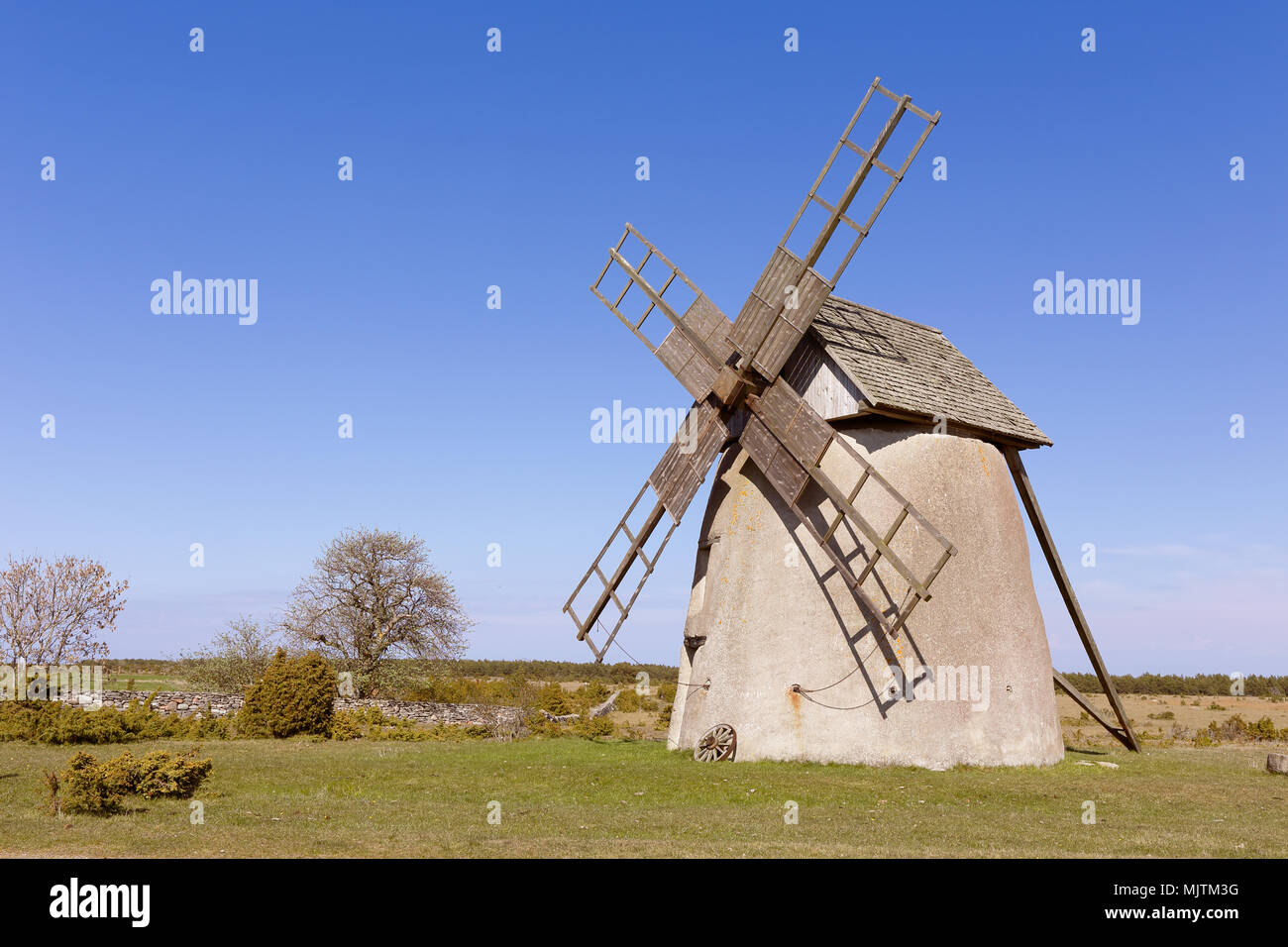 Windmill type tower mill with houses built of limestone located in Langhammars, Faro, in the province of Gotland, Sweden. Stock Photo