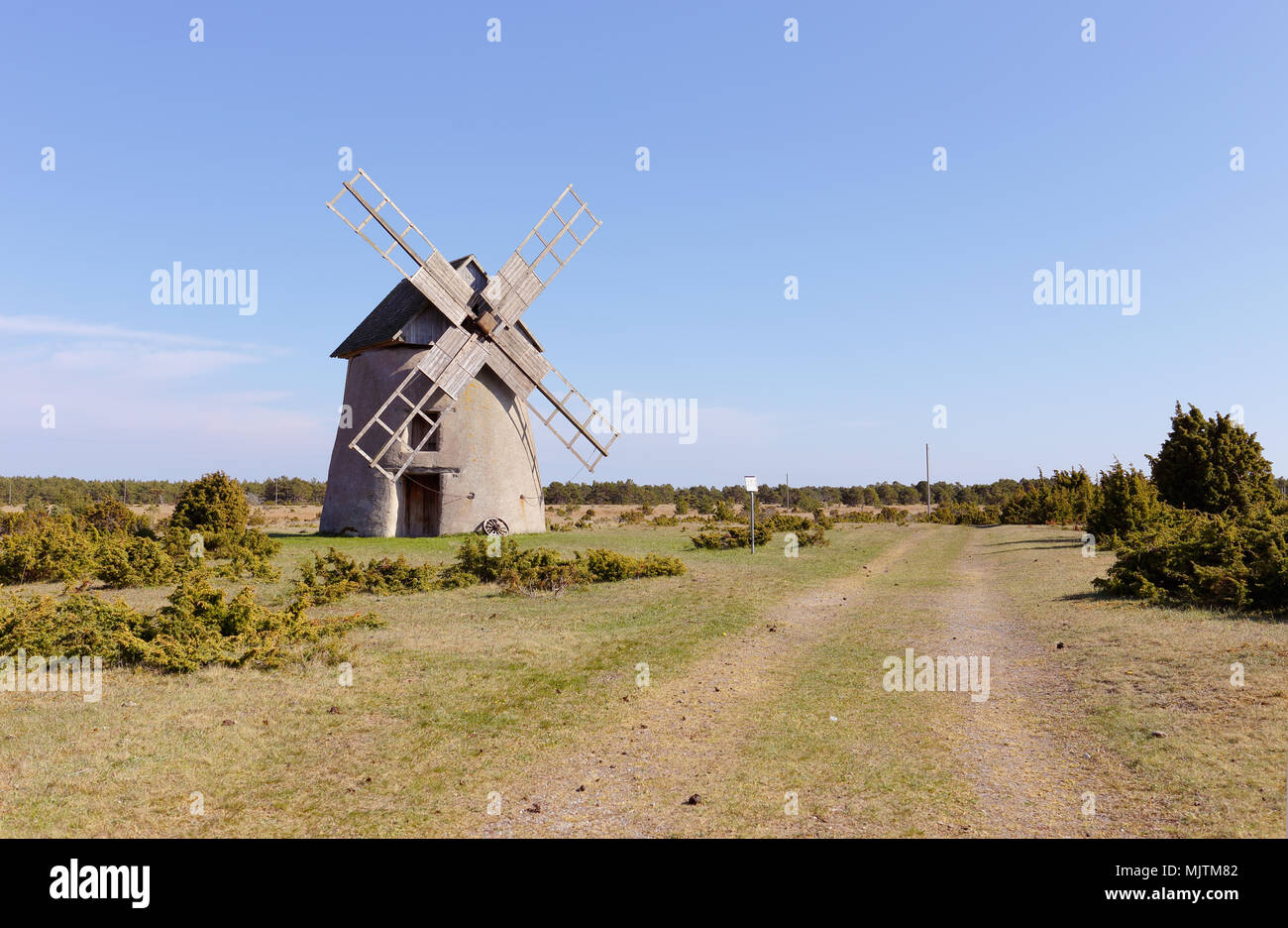Windmill type tower mill with houses built of limestone located in Langhammars, Faro, in the province of Gotland, Sweden. Stock Photo