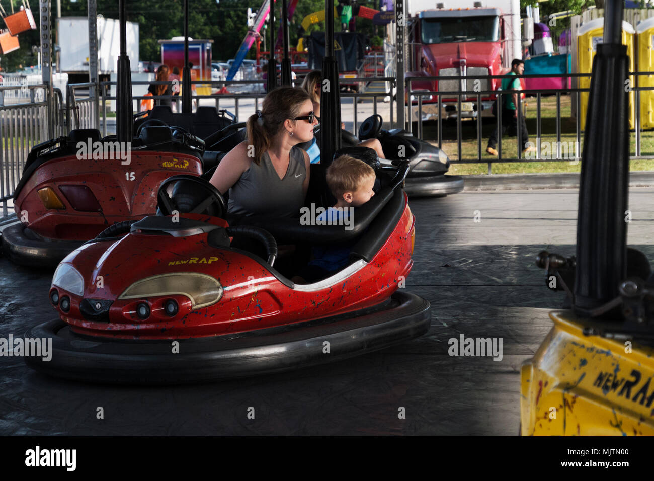 Mother and son watch for other cars in the bumper car ride at the 14th