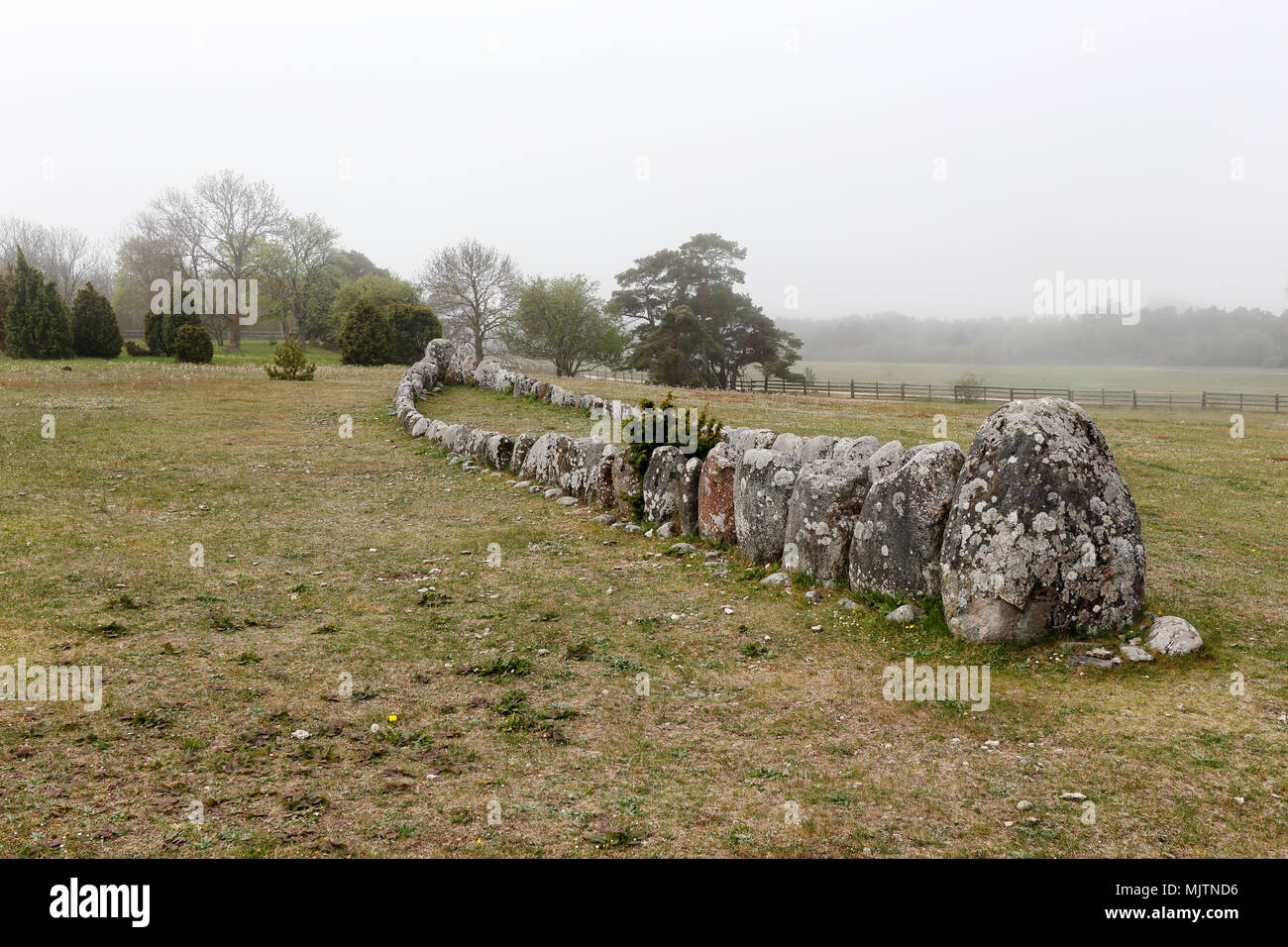 The ancient monument stone ship at Gannarve a fogy day in the Swedish province of Gotland. Stock Photo