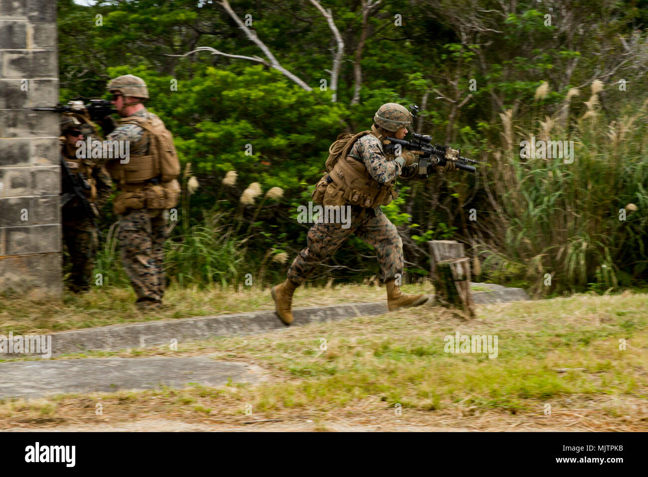 U.S. Marine Lance Cpl. Tyjier Brandy maneuvers towards the objective ...