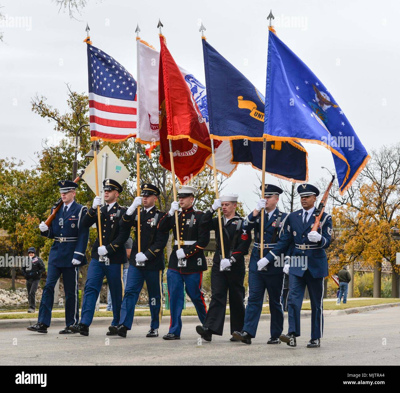 The Goodfellow Joint Service Color Guard marches during the Heroes Hunt parade in San Angelo, Texas, Dec. 7, 2017. The color guard led the parade along the Concho river walk. (U.S. Air Force photo by Aryn Lockhart/Released) Stock Photo