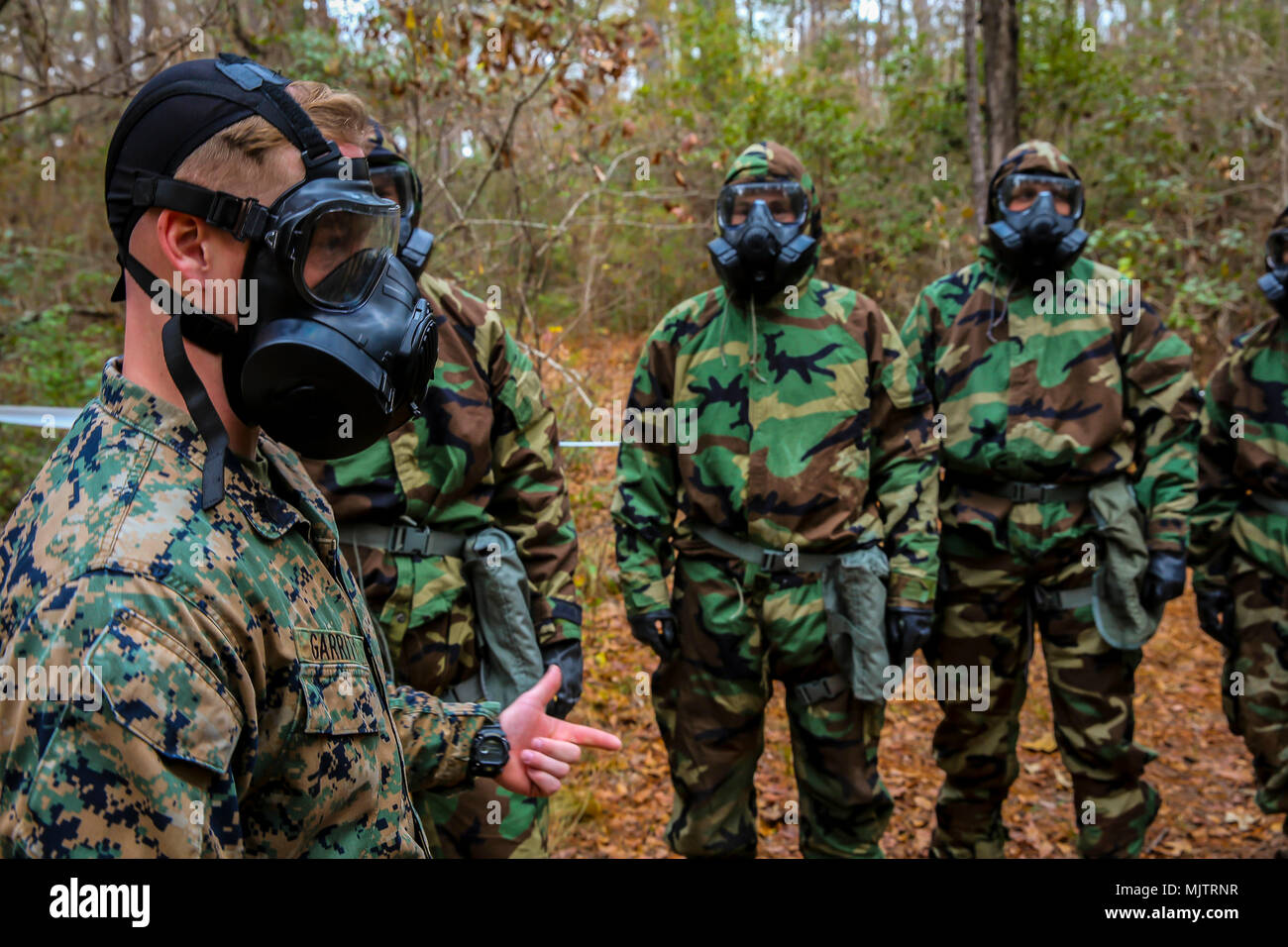 U.S. Marine Corps Sgt. Kevin Garrity, a chemical, biological, radiological and nuclear (CBRN) defense specialist with the 26th Marine Expeditionary Unit (MEU), instructs Marines during a CBRN training event at Camp Lejeune, N.C., Dec. 18, 2017. The training provided Marines with a basic knowledge of how to effectively utilize their equipment and to defend against CBRN attacks. (U.S Marine Corps photo by Cpl. Austin M. Livingston) Stock Photo