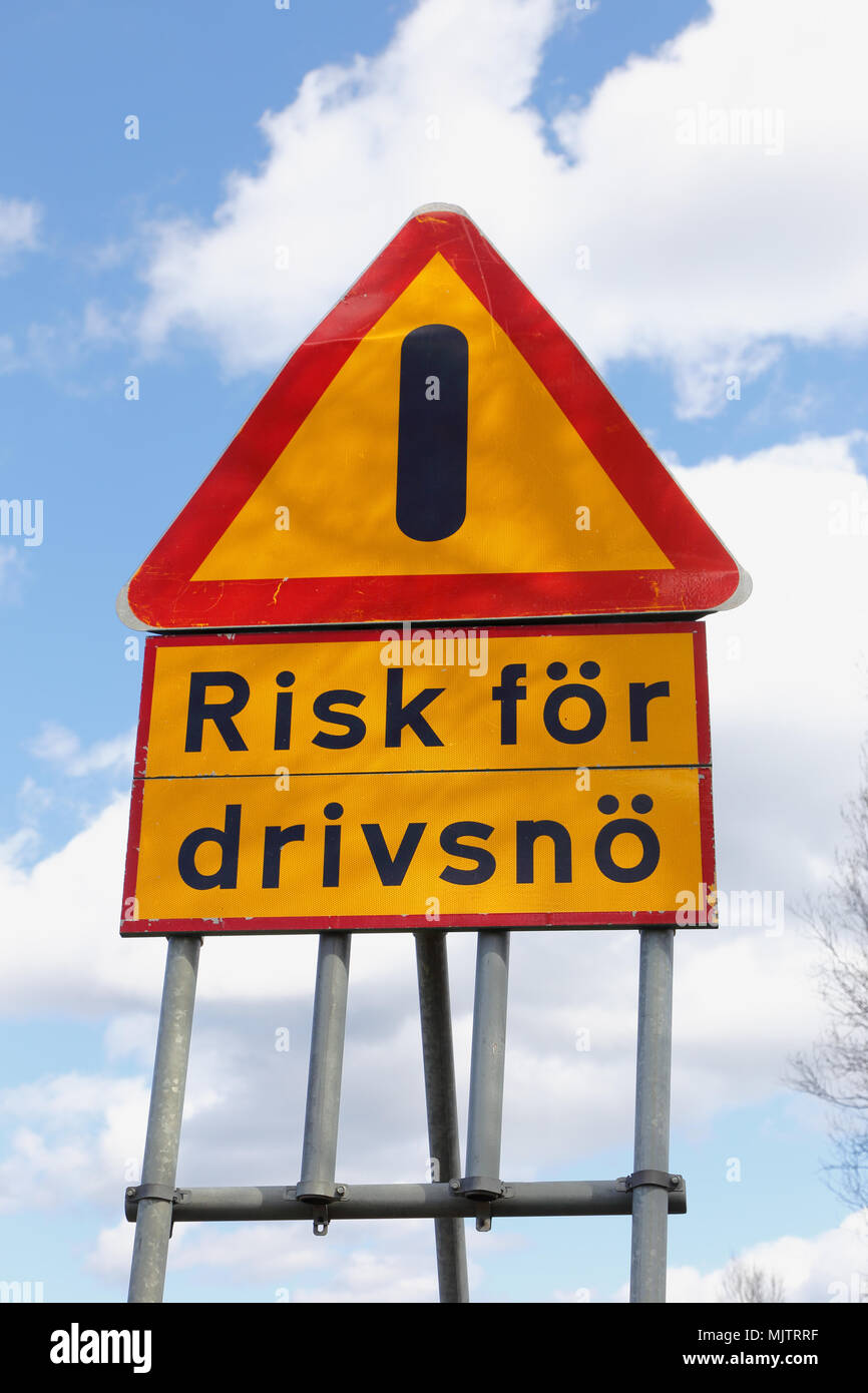 Swedish road sign for other danger  with additional sign danger of drifting snow. Stock Photo