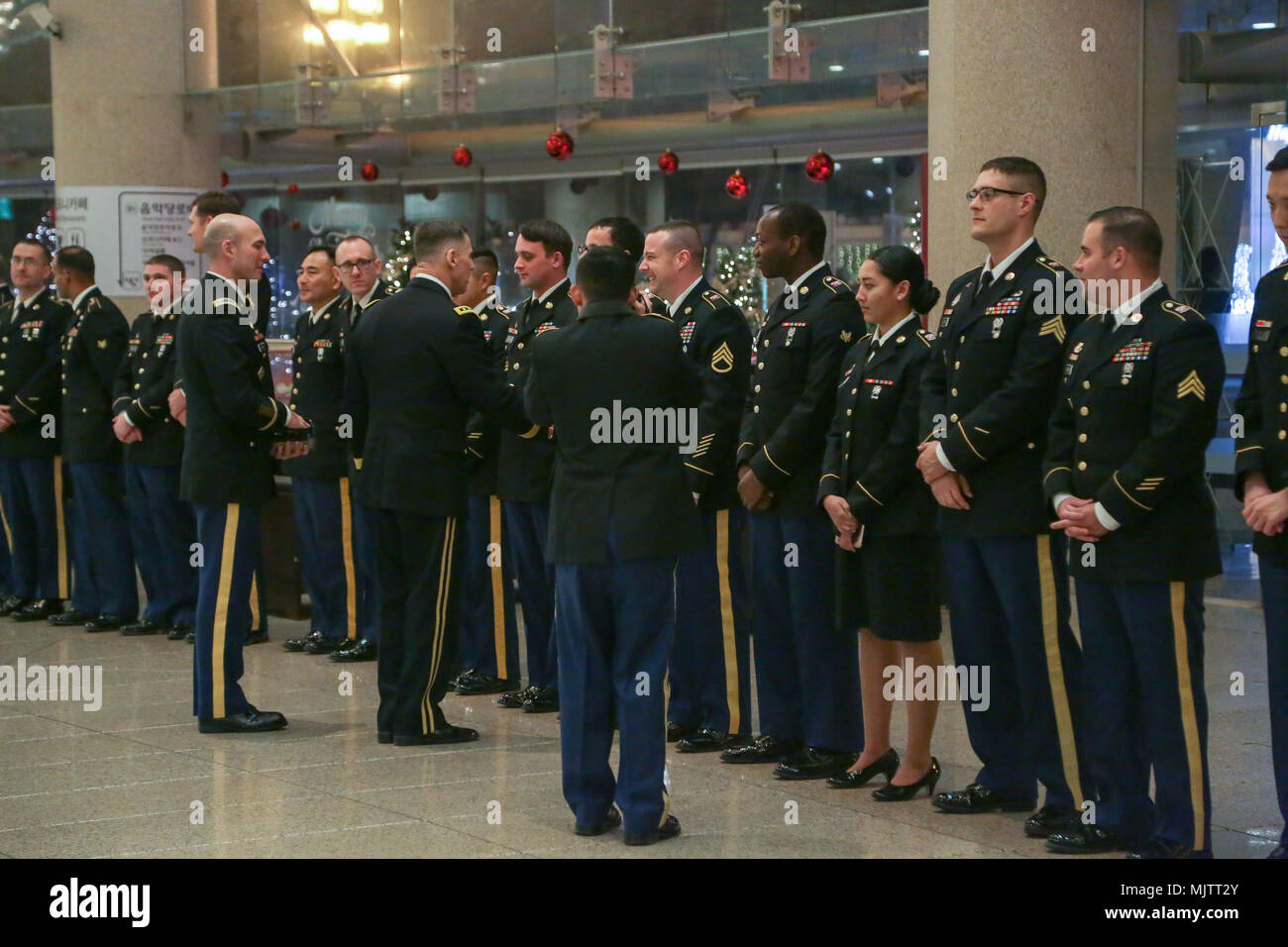 U.S Army Lt. Gen. Thomas S. Vandal commander of the Eighth army, presents coins to the Eighth Army Band after the Holiday concert in Seoul, Korea Dec. 17, 2017. The concert was hosted by the Eighth Army command in conjunction with local community leaders during the holiday season to promote harmonious relations between the U.S. Army and the Republic of Korea (ROK). Over 1500 U.S. Soldiers and ROK soldiers attended performances by the Eighth Army Band and the Prime Philharmonic Orchestra . (U.S. Army photo by Pfc. Edward Randolph) Stock Photo