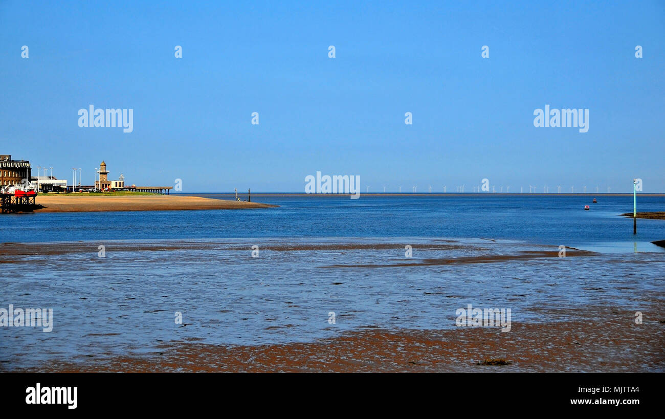 Blue sky view from Knott End to the mouth of the River Wyre, with Fleetwood Pier, sea front Lower Lighthouse, Irish Sea wind turbines, Lancashire, UK Stock Photo