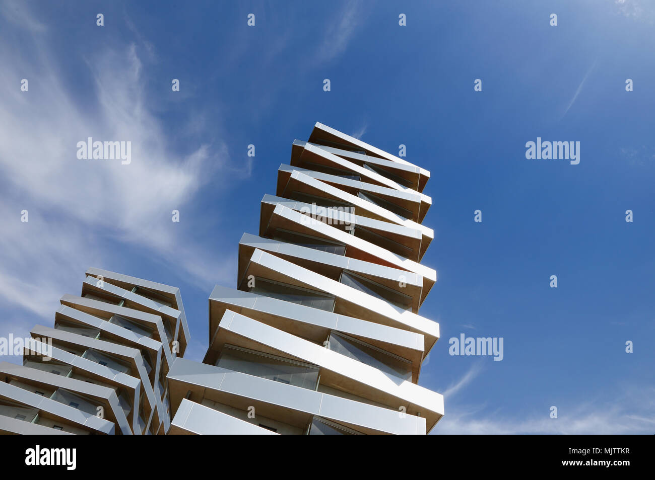 Two modern  buildings stacked like pizza boxes strive towards the sky. Stock Photo