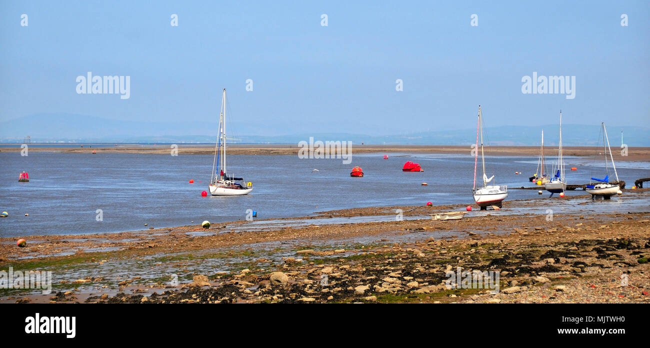 Blue sky view, west to Wyre Light and Black Combe and Lake District hills of beached and anchored yachts, River Wyre mouth, Knott End, Lancashire, UK Stock Photo