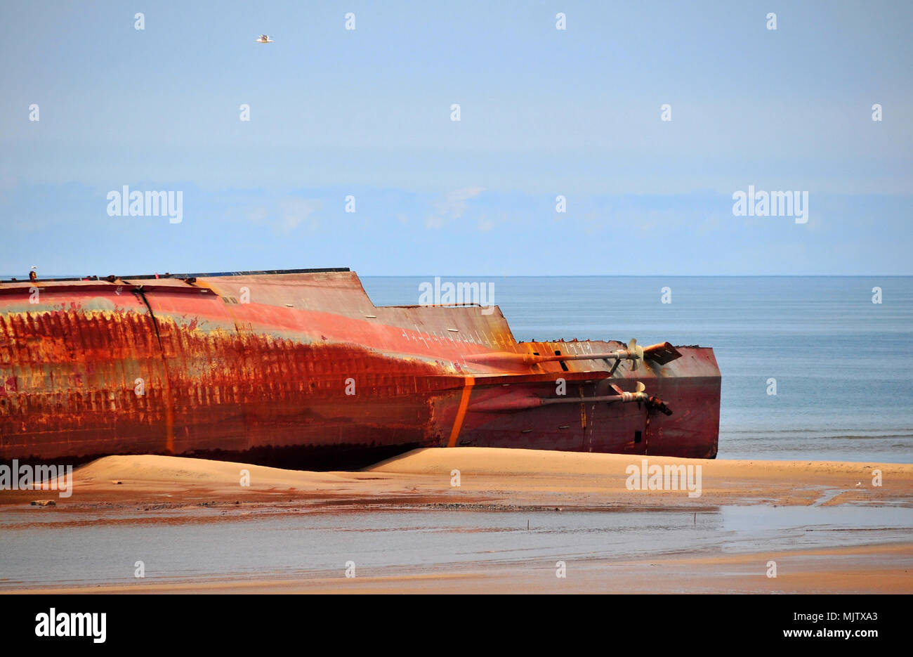 Blue sky view, looking seaward, stern Riverdance Ferry Wreck, two propellers, dismantled plates, lying side-on sand beach, Anchorsholme, Blackpool, UK Stock Photo