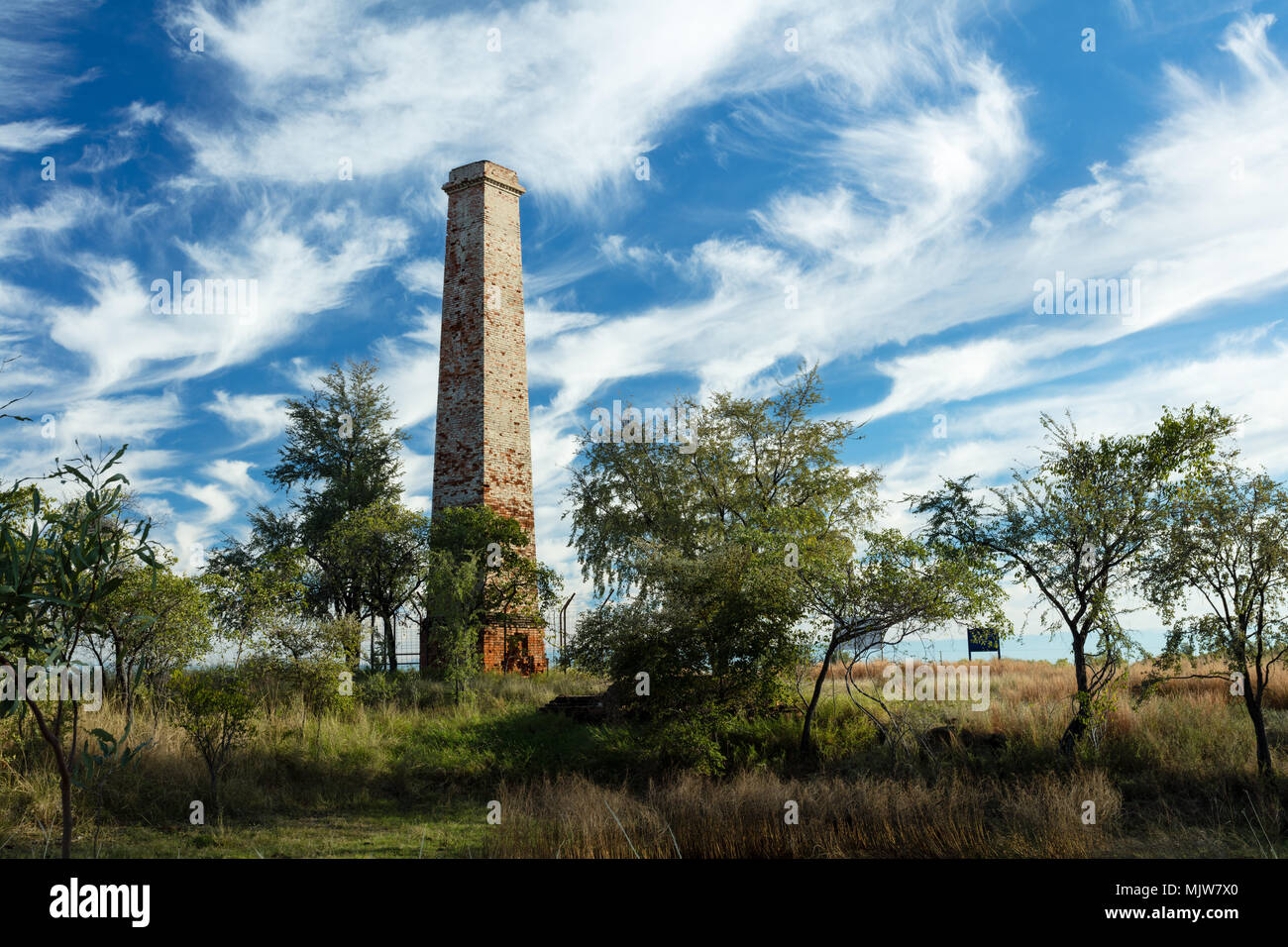 Georgetown, Queensland, Australia. Dramatic cirrus clouds over the old chimney at the Cumberland Gold mine near Georgetown on the Savannah Way in outb Stock Photo