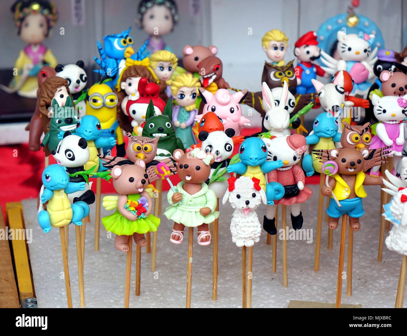 KAOHSIUNG, TAIWAN -- FEBRUARY 16, 2018: A street vendor sells colorful dough figurines, a Chinese traditional folk art with a modern twist. Stock Photo