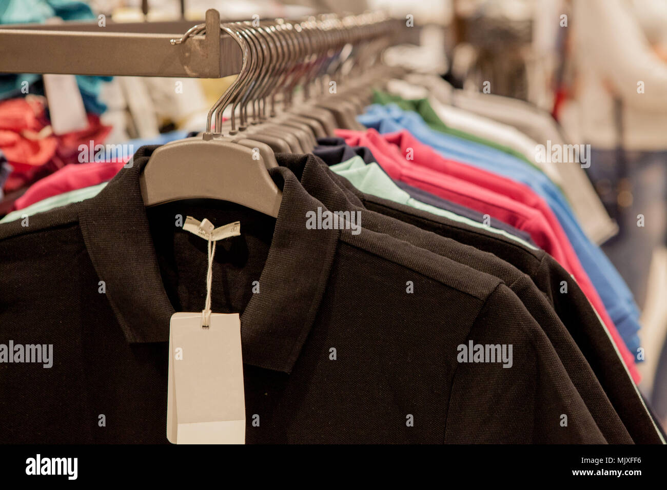 Colorful tshirts on hangers. Men's stylish clothes. Showcase, sale