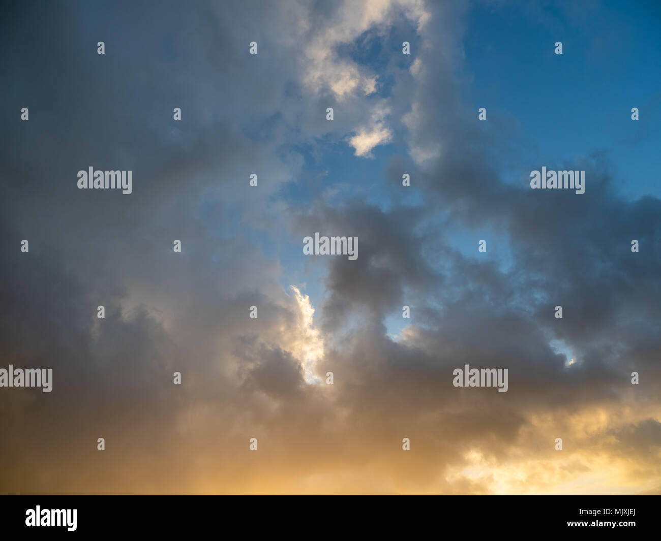 strange clouds in the sky at sunset in october Stock Photo