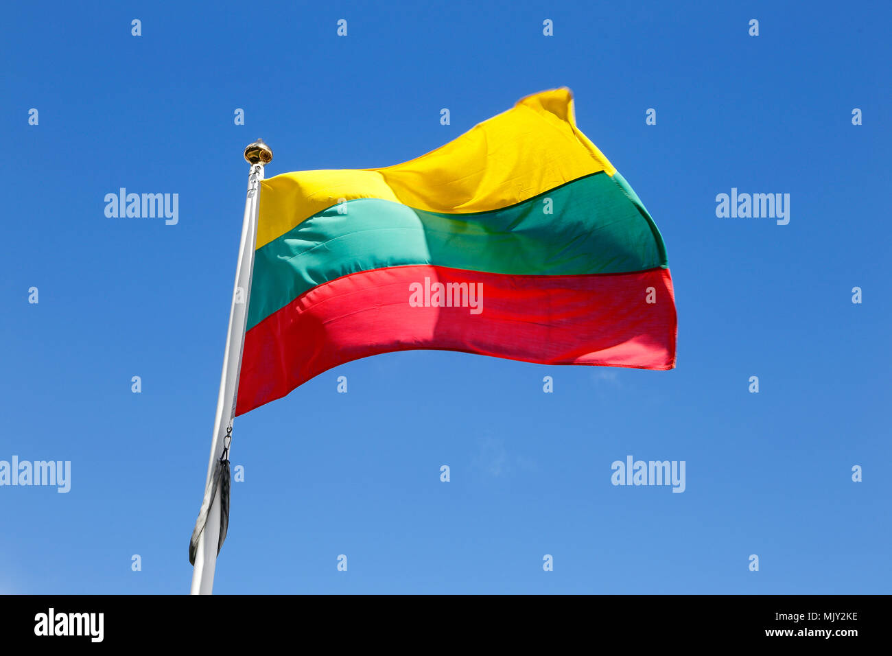 Lithuanian flag waving in thewind on a blue sky. Stock Photo
