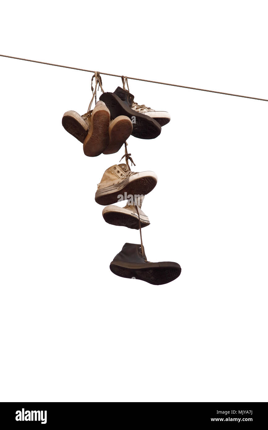 Shoes hanging on wire isolated on white background. Stock Photo