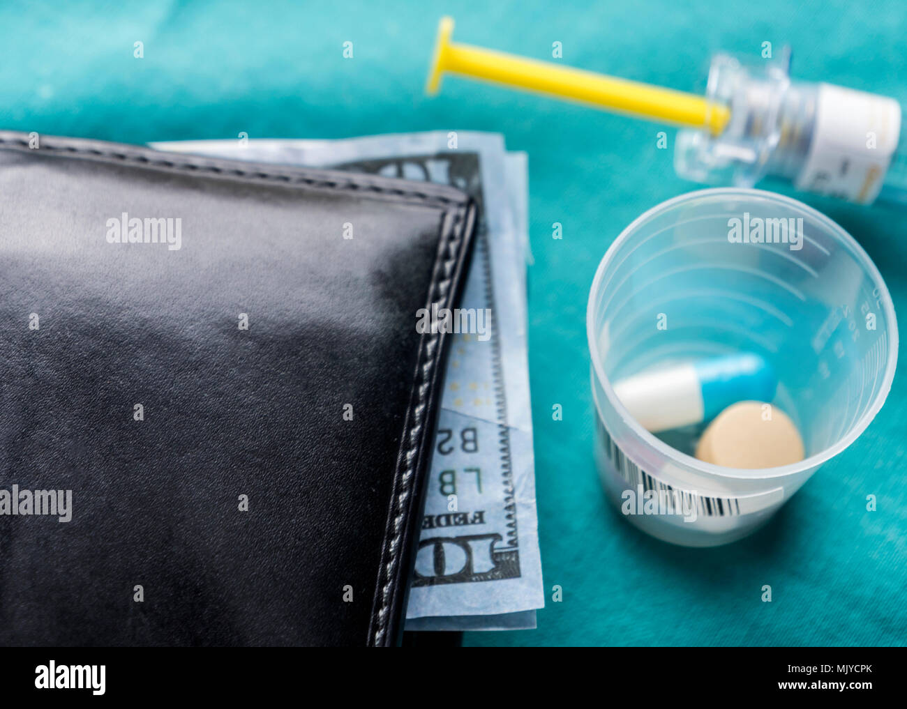 Wallet with dollar next to medicines, concept of copayment health Stock Photo