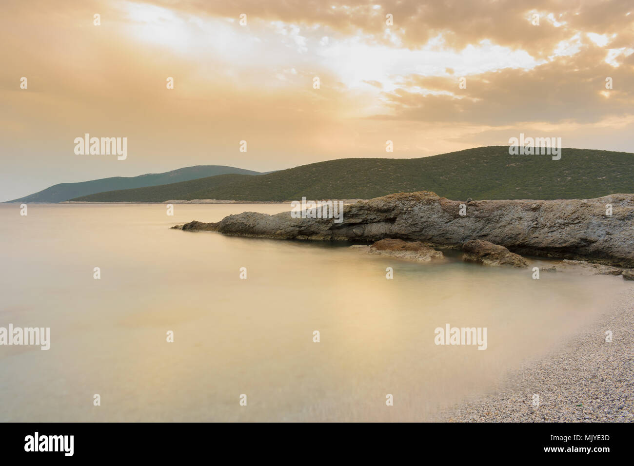 Sunset seascape - Long exposure rock formations into the sea at sunset Stock Photo