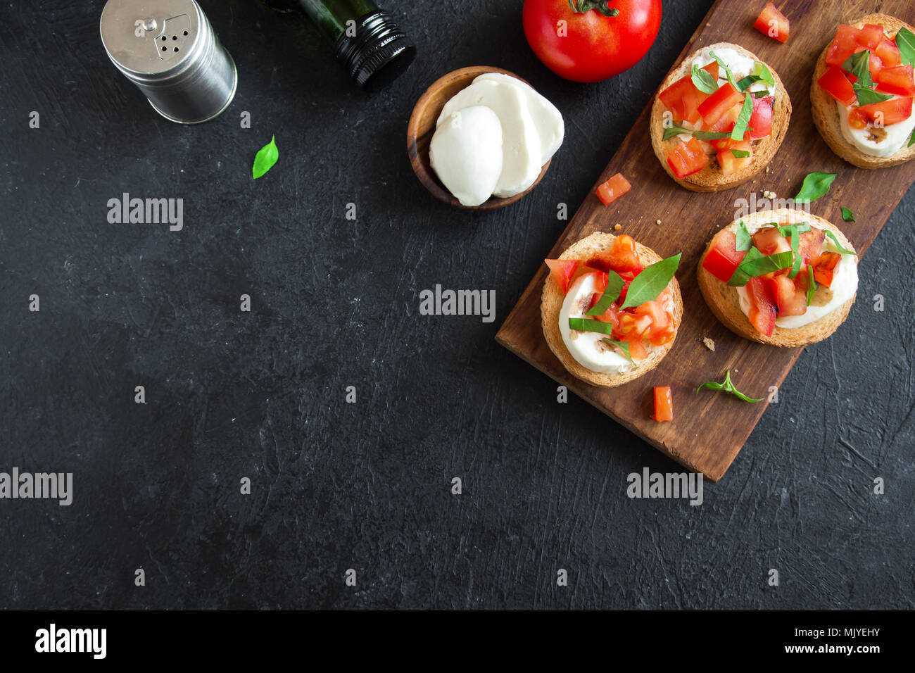 Italian bruschetta with chopped tomatoes, basil, mozzarella cheese and