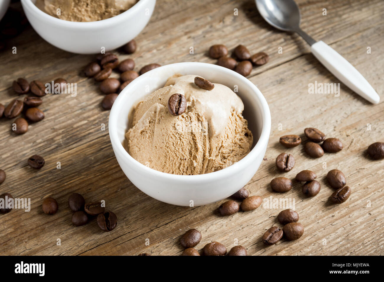 Coffee ice cream on wooden background. Homemade coffee gelato ice cream
