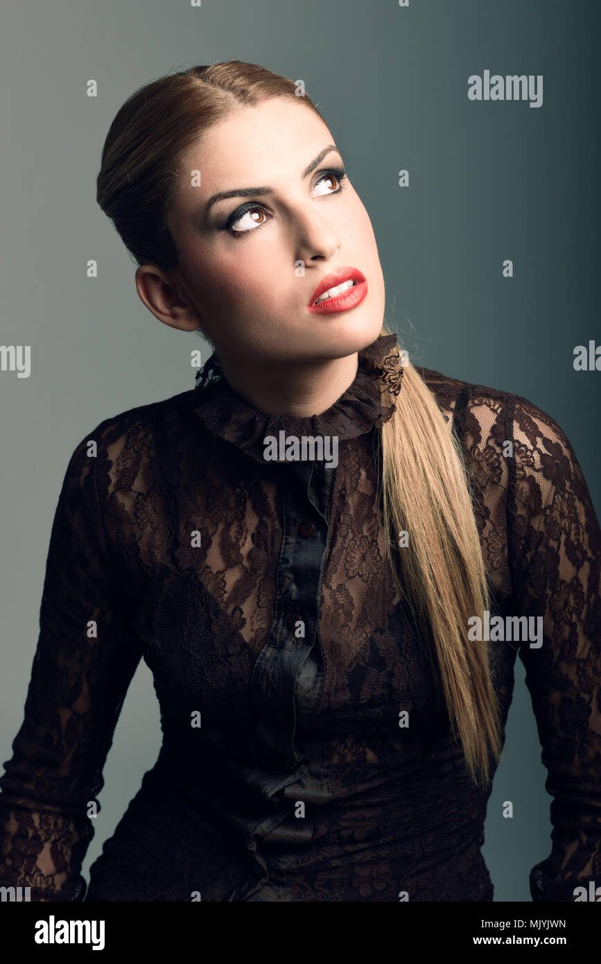 Blonde woman wearing shirt with a ponytail. Studio shot Stock Photo