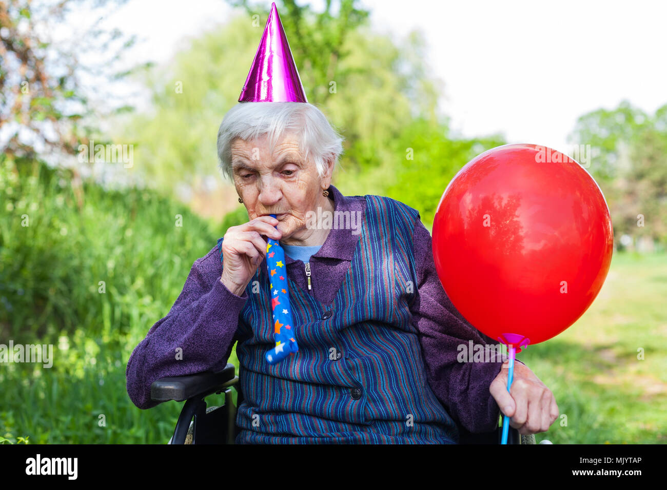 Elderly Woman In A Wheelchair Celebrating Birthday In The Park Stock Photo Alamy