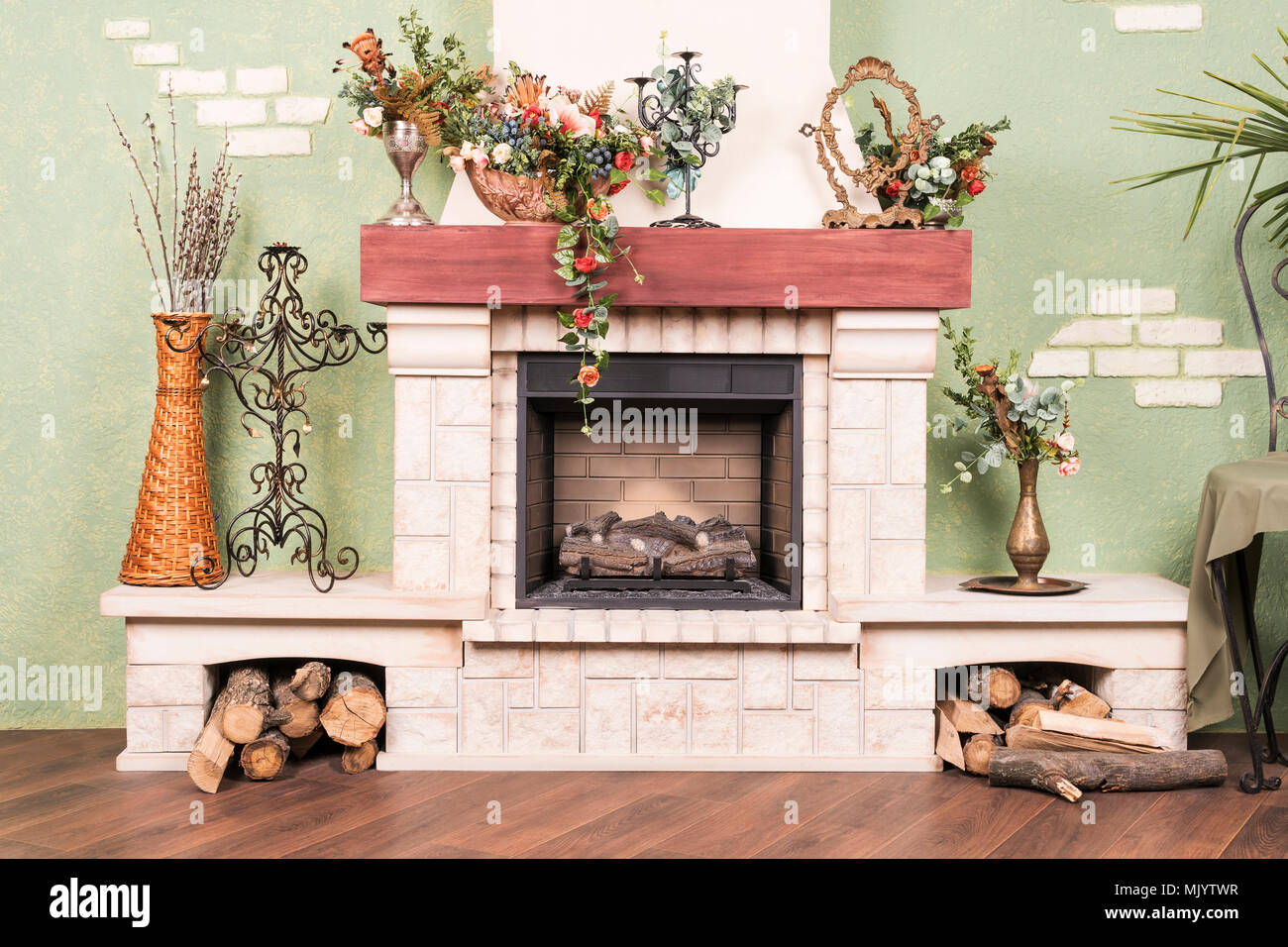 Decorative beautiful fireplace, without fire, with flowers and