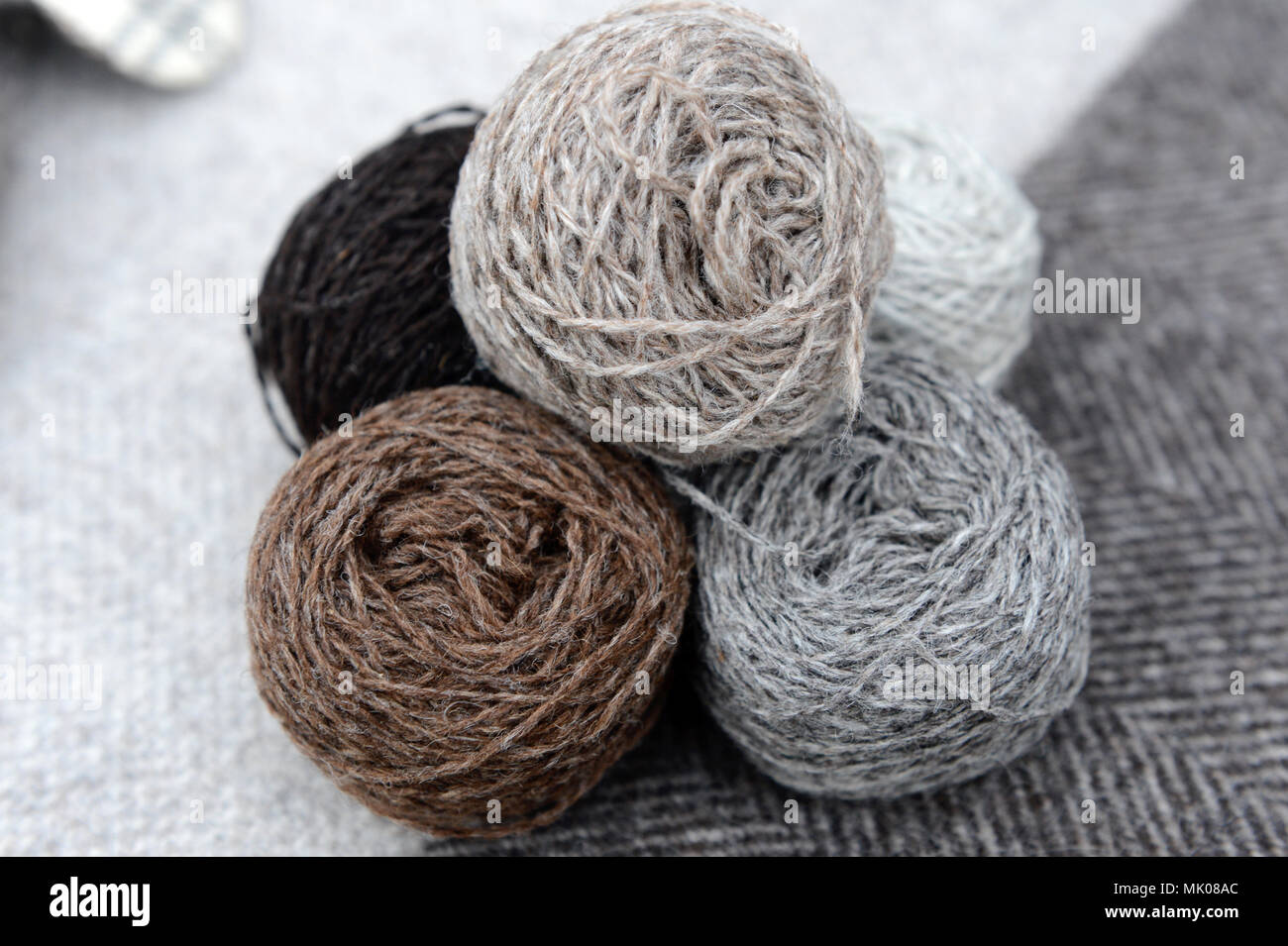 Balls and cones of naturally dyed Shetland wool that are the colours of ...