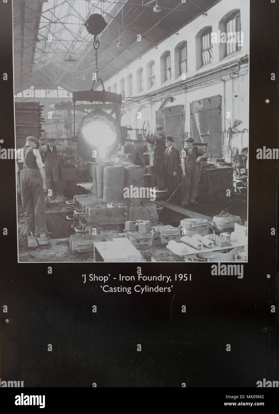 Public display of old historic images about the GWR works, Swindon, Wiltshire, England, UK - J shop iron foundry 1951 casting cylinders Stock Photo