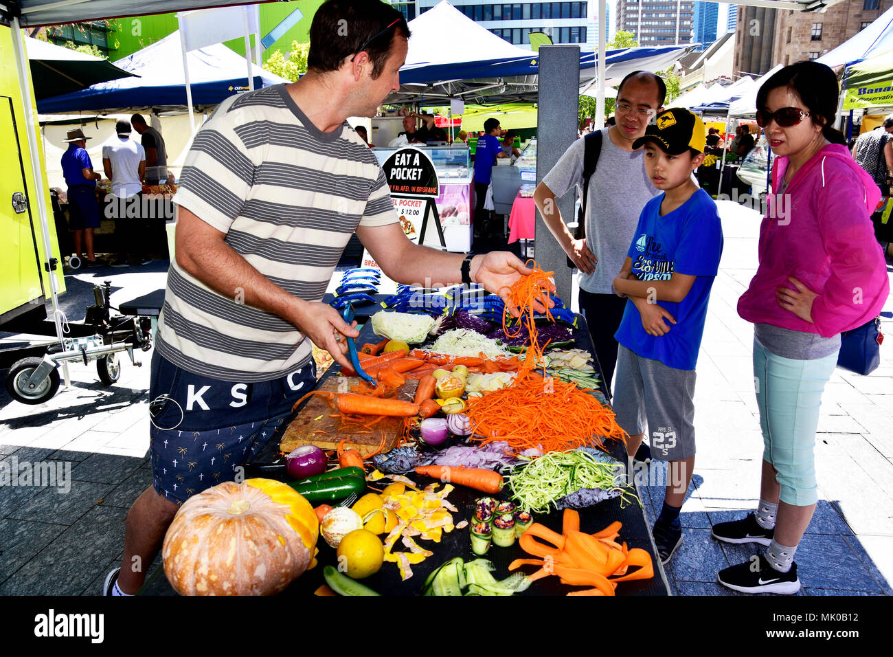SPROOKER SELLING A KITCHEN UTENSIL AT A MARKET IN BRISBANE Stock Photo