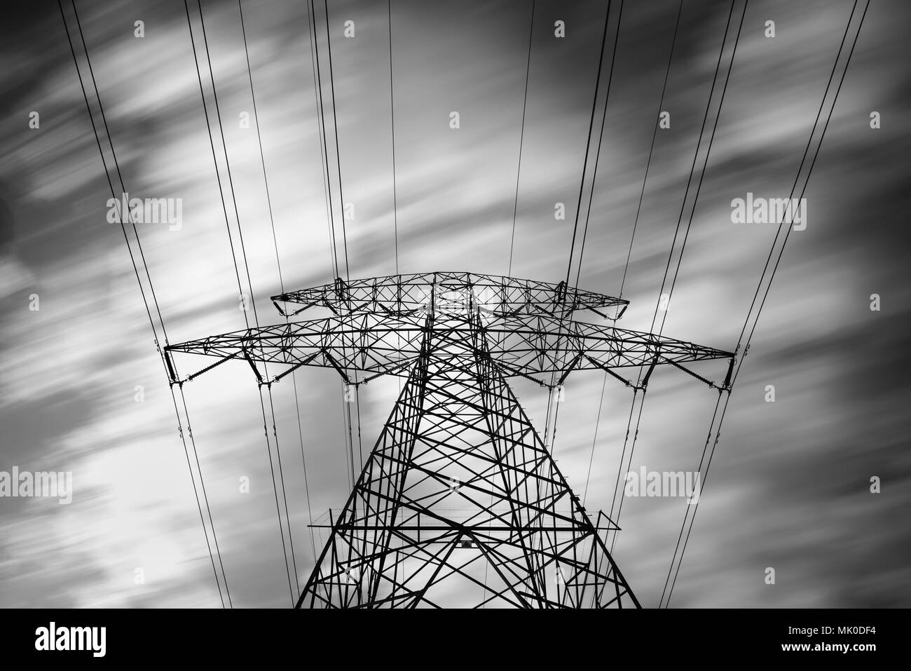 Details of a metallic structure of a high voltage electricity tower holding transmission wires to transfer electrical energy Stock Photo