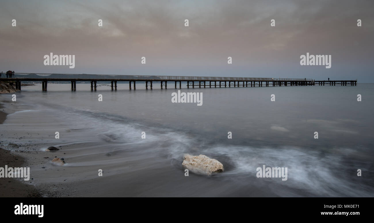 Seascape with jetty during a dramatic cloudy sunset at Polis town area in Paphos, Cyprus Stock Photo