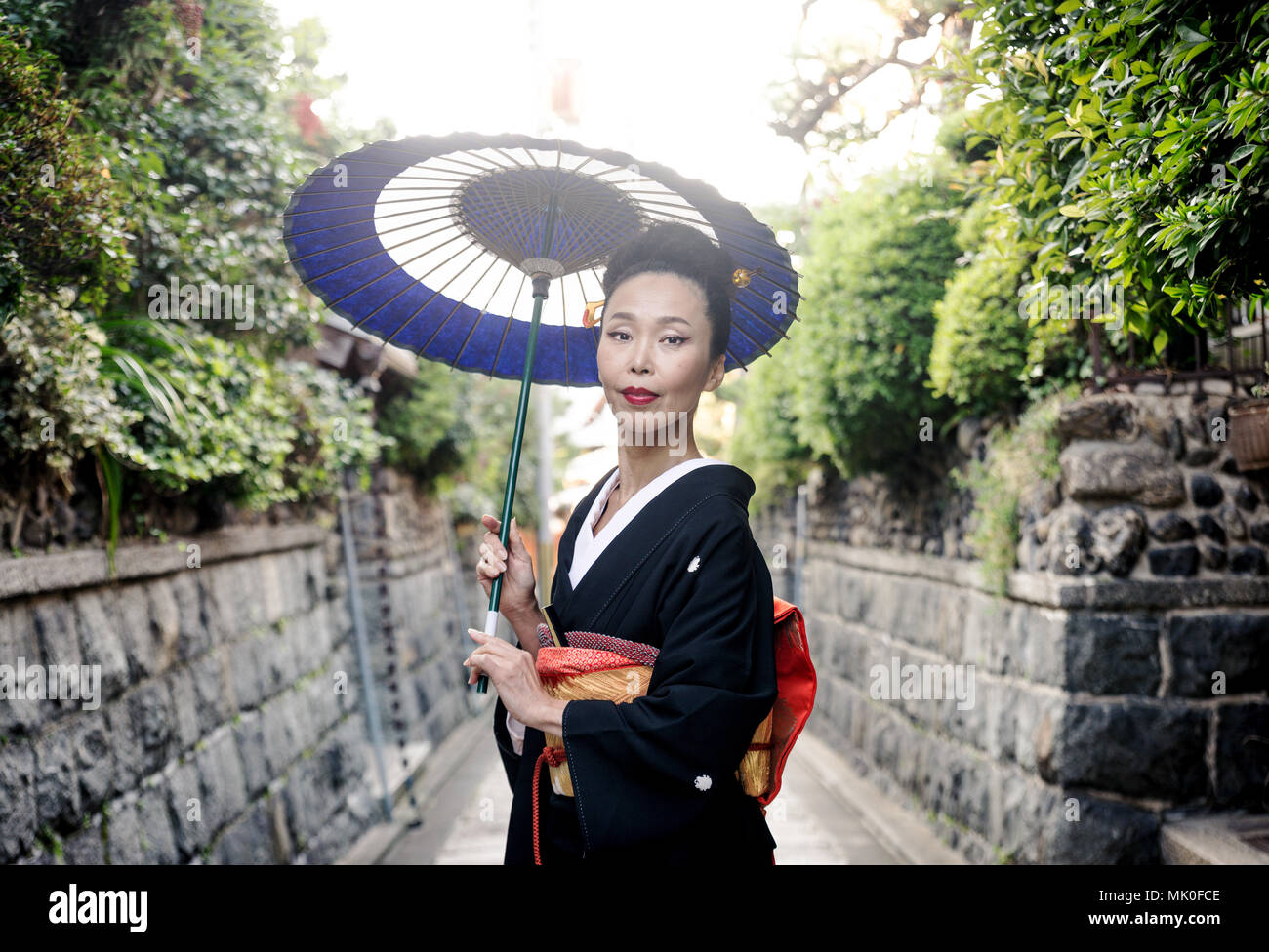 Japanese woman wearing traditional dress and walking outdoors Stock Photo Alamy