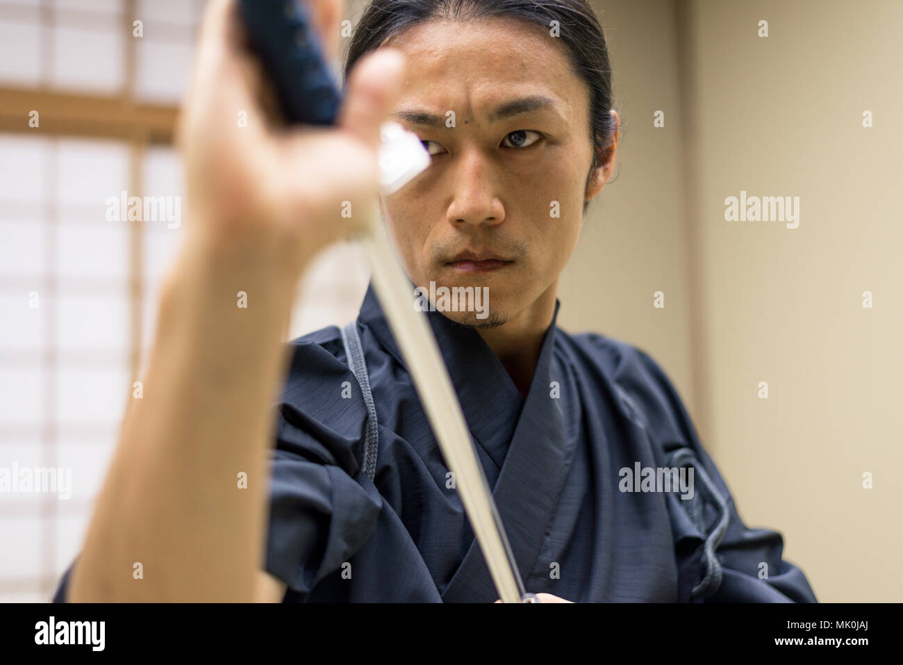 Japanese martial arts athlete training kendo in a dojo Samaurai practicing in a gym Stock