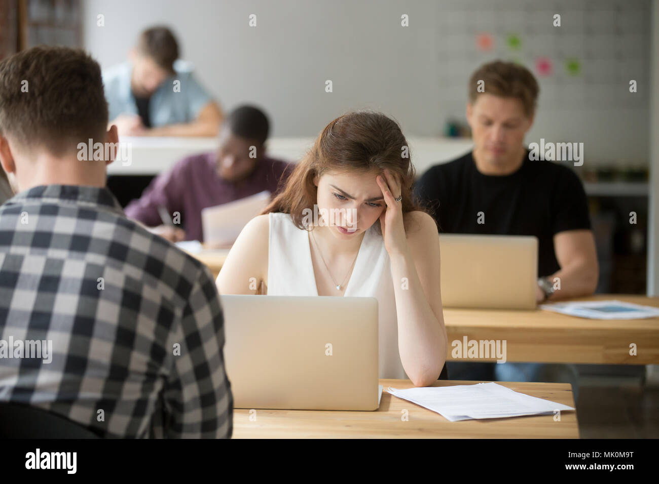 Disappointed female sad about bad stock market news Stock Photo