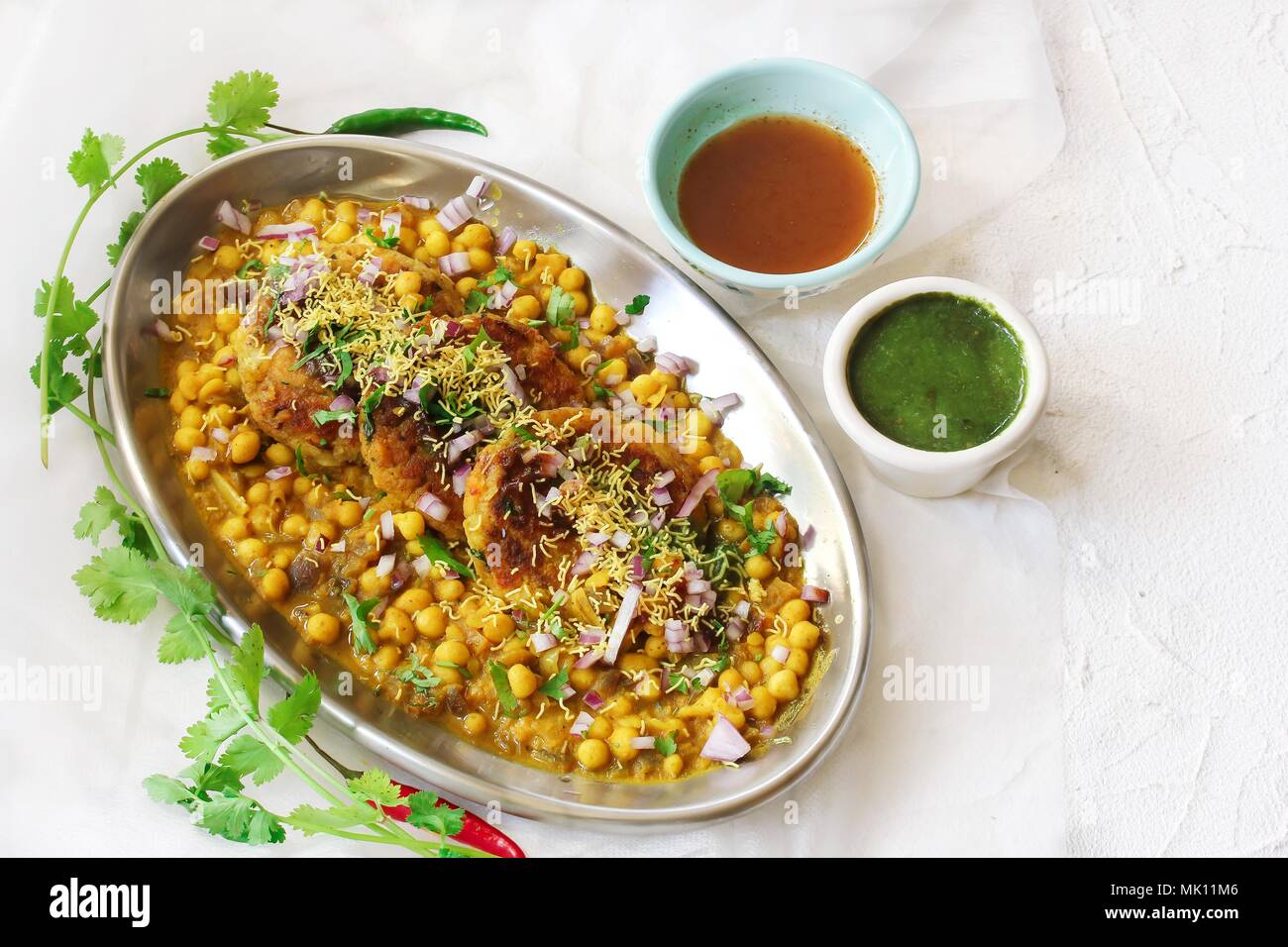 Ragda Pattice / Mumbai Street food(Chat)  made of potato Patties white beans serve with tamarind cilantro chutney Stock Photo