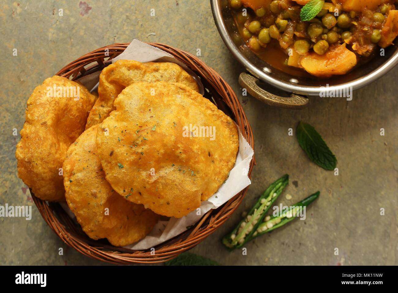 Indian Masala Poori / Puri served with Aloo Mutter , selective focus Stock Photo