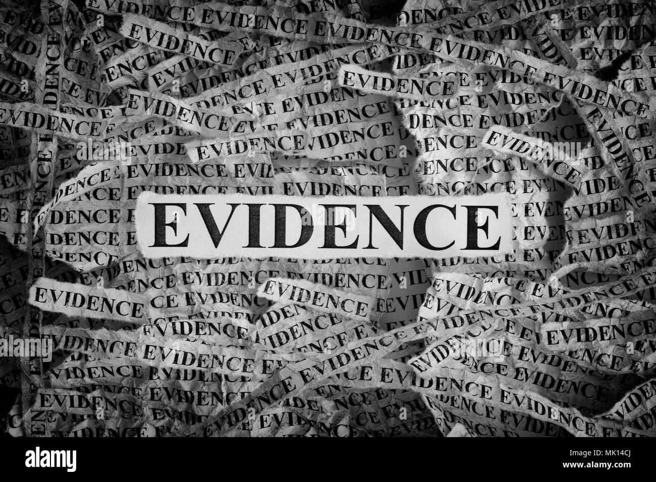 Evidence. Torn pieces of paper with the words Evidence. Concept Image. Black and White. Closeup. Stock Photo