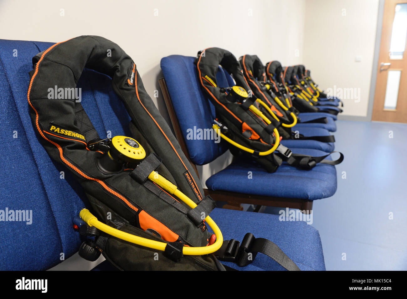 Briefing room with life jackets and breathing apparatus at Sumburgh airport for offshore workers to wear when going offshore to oilrigs Stock Photo