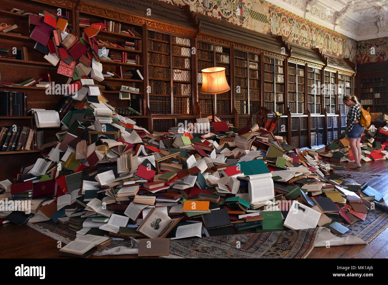 Visitors View A Cascade Of Books Flowing From Bookcases At Blickling Hall In Norfolk As Part Of 