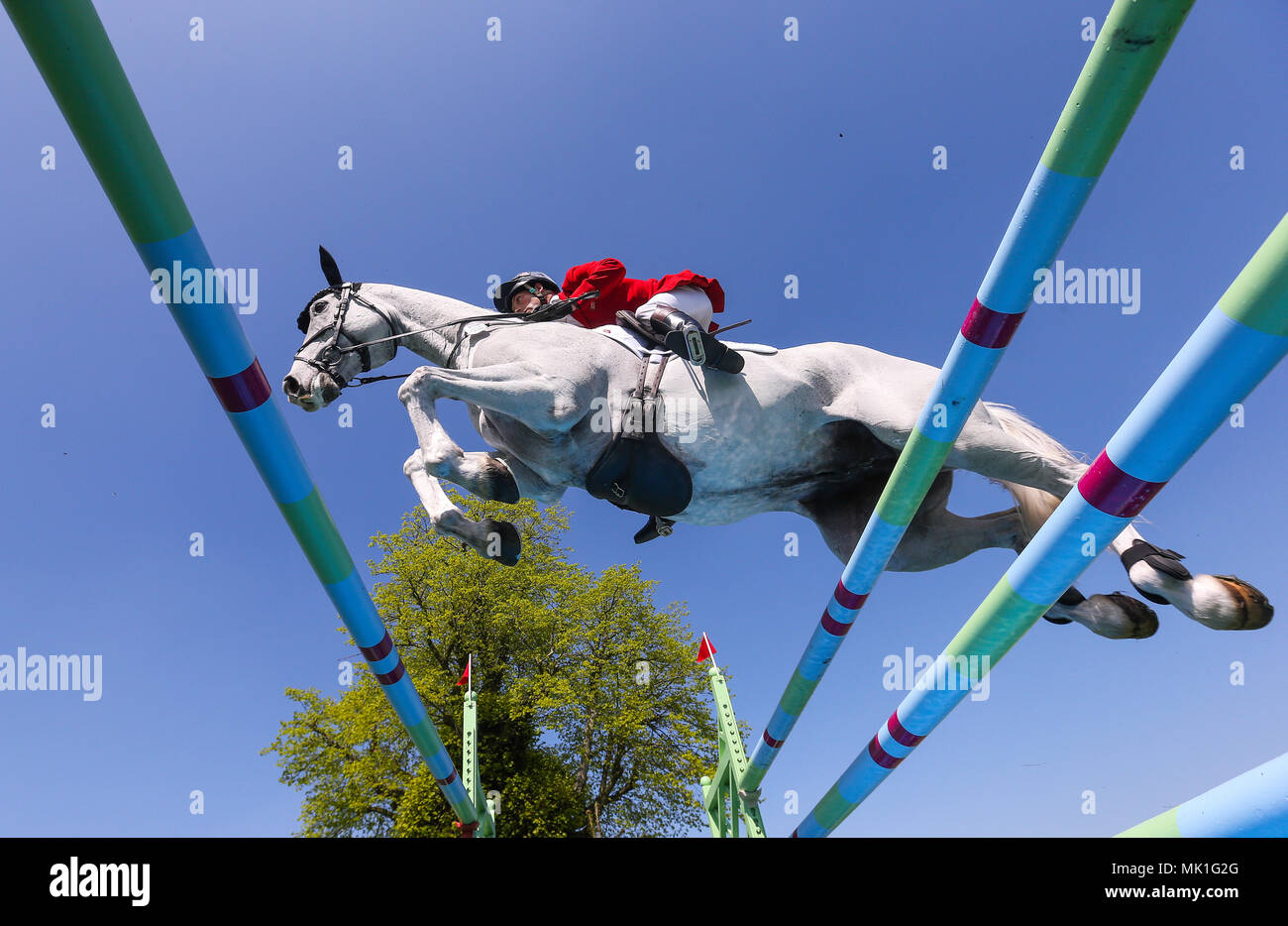 Harry Meade with Away Cruising jumps the last in the show jumping round during day five of the Mitsubishi Motors Badminton Horse Trials at The Badminton Estate, Gloucestershire. Stock Photo