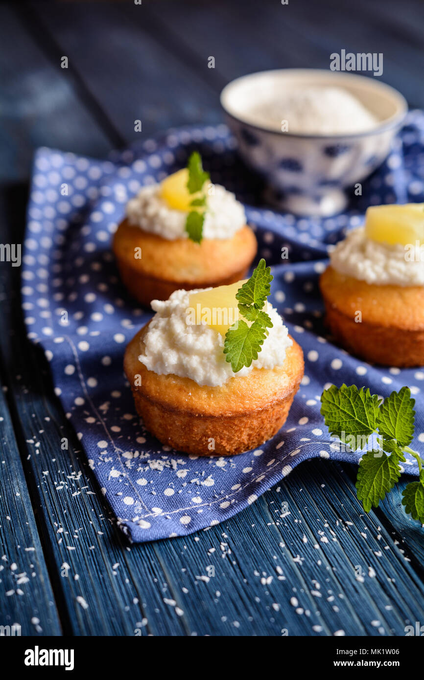Coconut and pineapple muffins with yoghurt topping Stock Photo Alamy