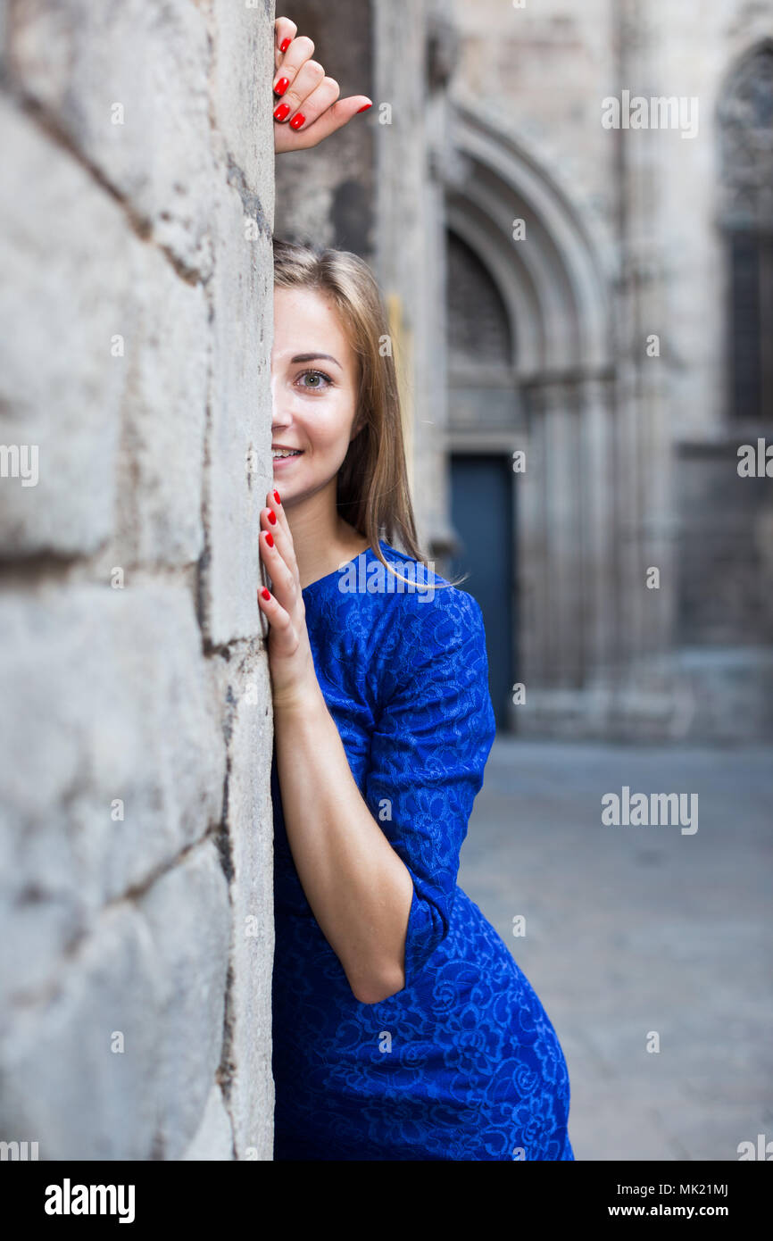 Elegant girl is posing in blue dress near old wall on the street Stock ...