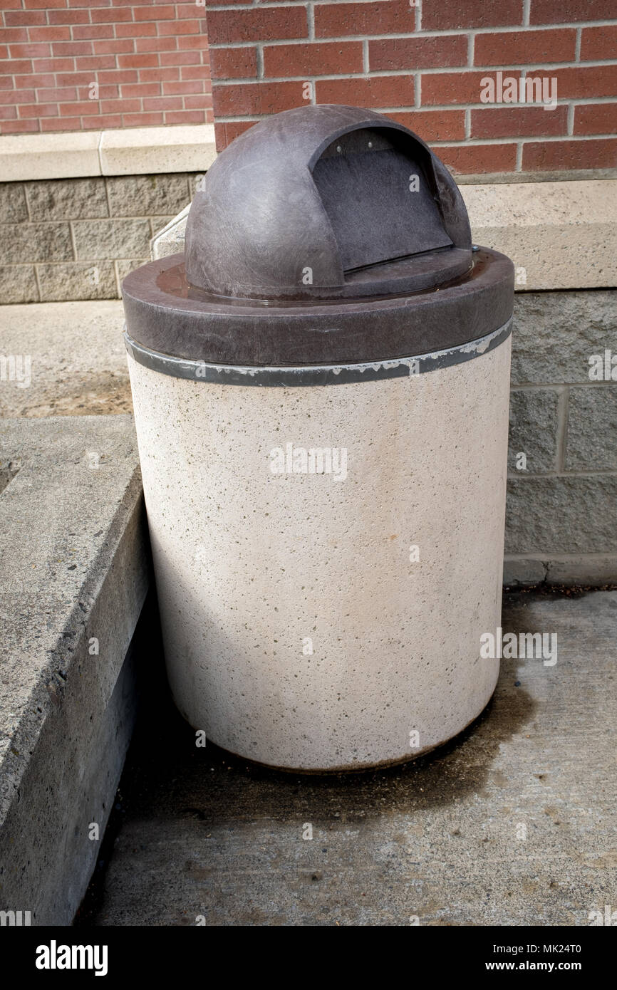 Industrial cement trash can with a dark brown top Stock Photo Alamy