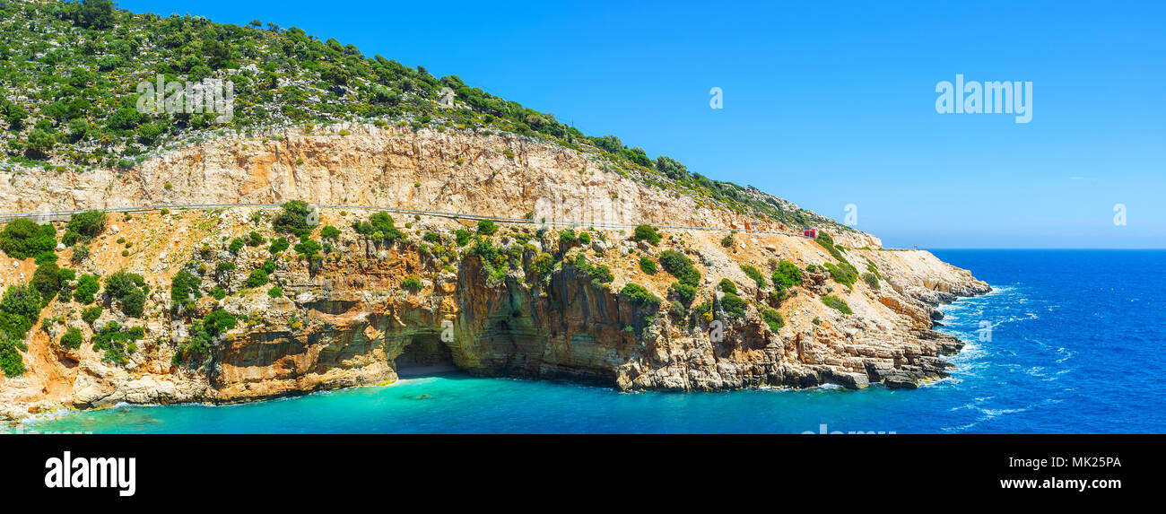 Panorama of the rocky slope with sea cave at the narrow natural haven, known as Kaputas beach, Turkey. Stock Photo