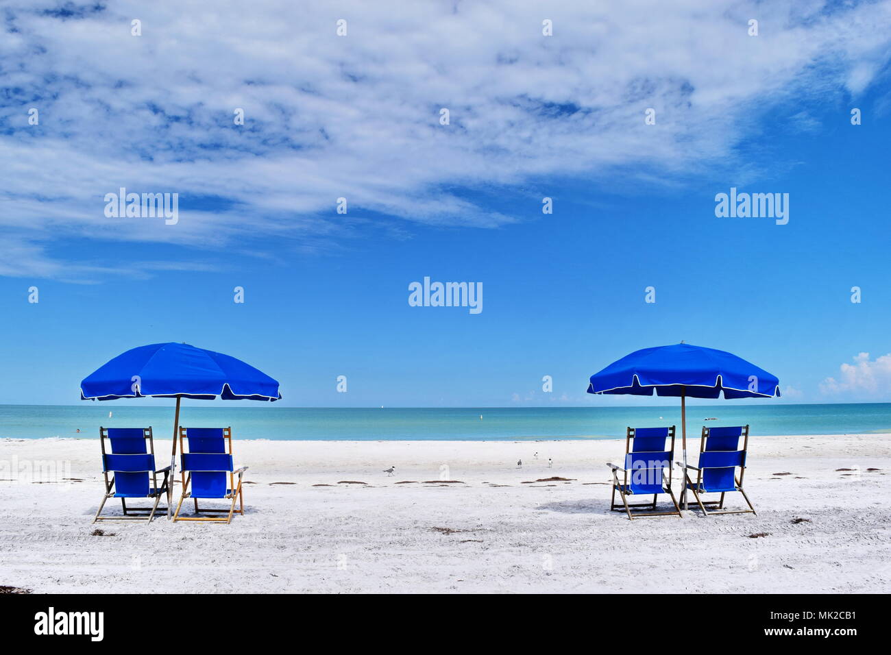 Chairs and umbrellas on bright cloudy day on Caladesi Island State Park
