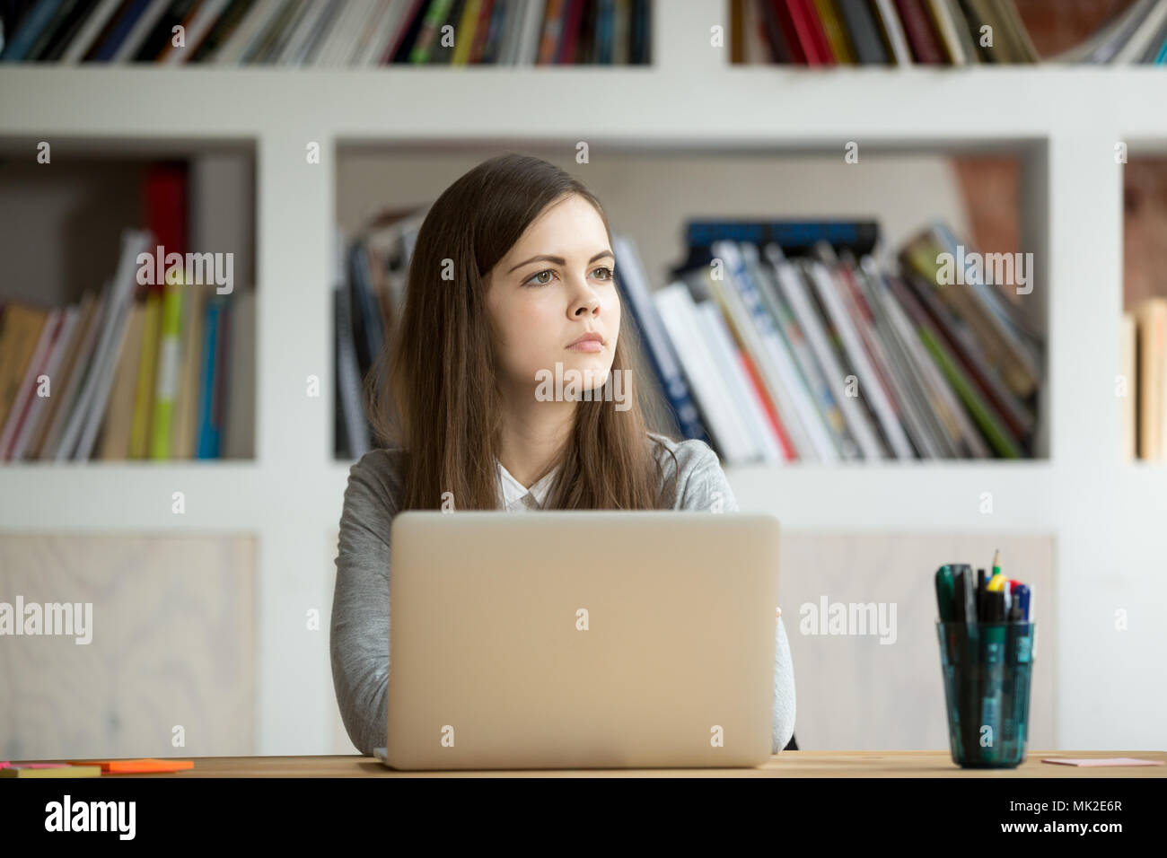 Concentrated businesswoman thinking about problem solution Stock Photo