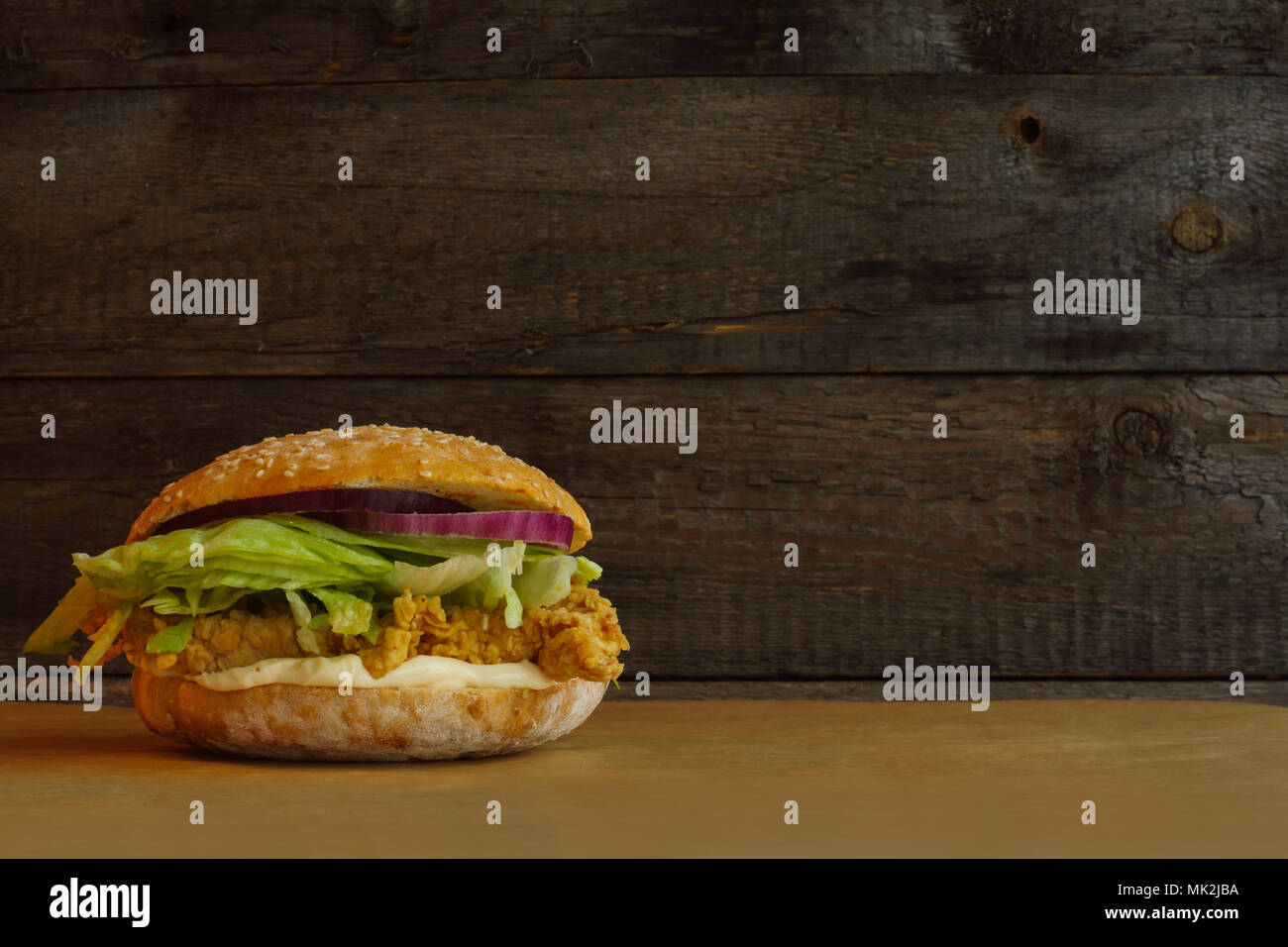 Classic Chicken Burger Isolated on wooden background Stock Photo