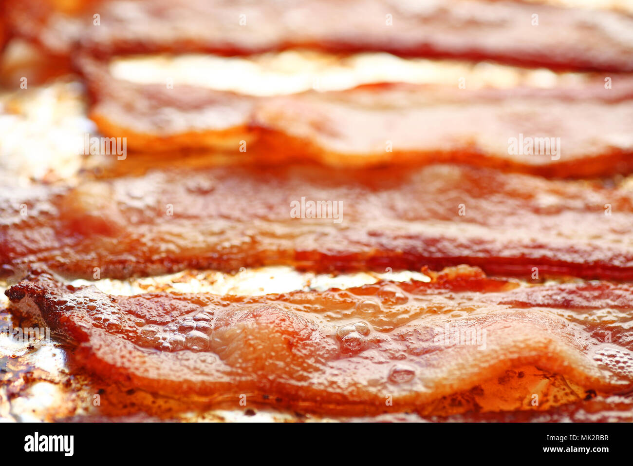 Ovenfried bacon on foillined pan Stock Photo Alamy