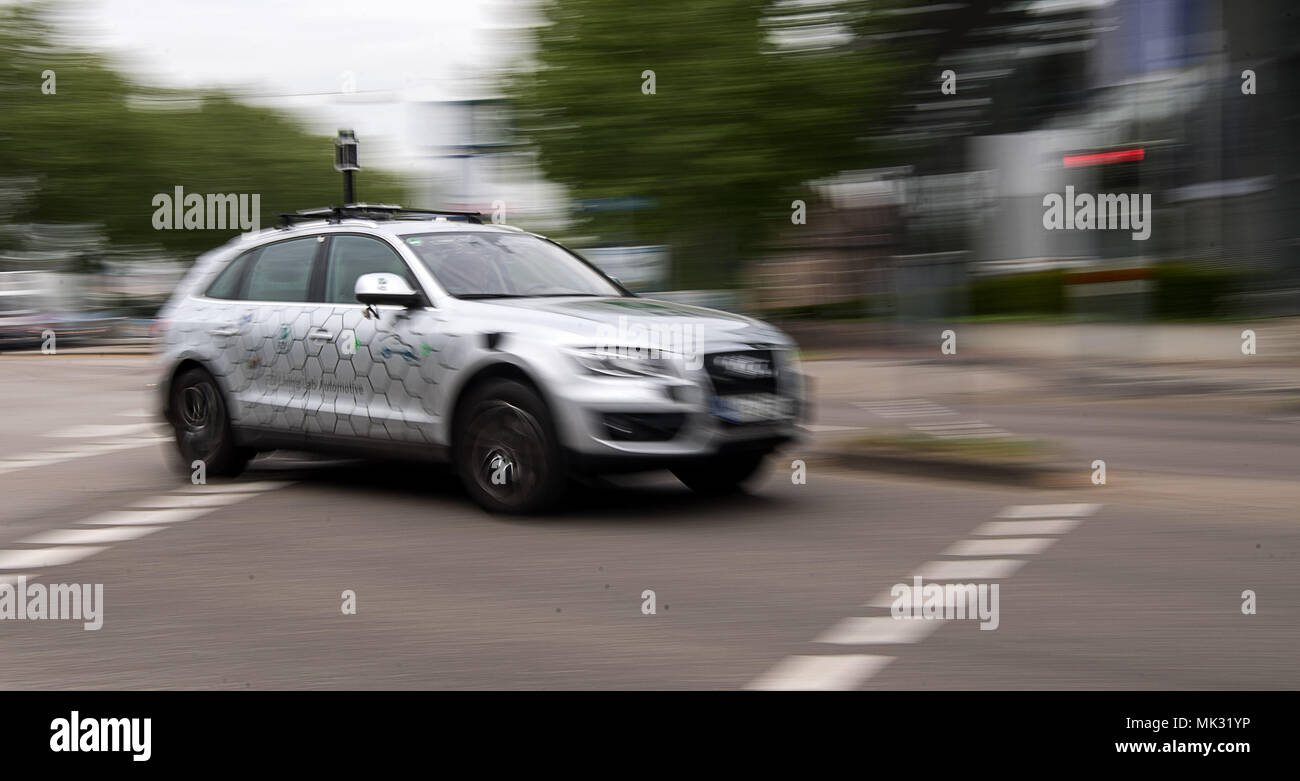 03 May 2018, Germany, Karlsruhe: An autonomous vehicle of the research centre Informatik is on the road during the opening of the 'Testfelds Autonomes Fahren' (lit. test field autonomous driving). The project is meant to sound the possibilities of driverless cars on selected tracks between Karlsruhe, Bruchsal and Heilbronn. Photo: Sebastian Gollnow/dpa Stock Photo